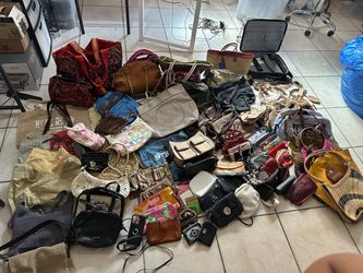 A lot of used bags, totes and wallets