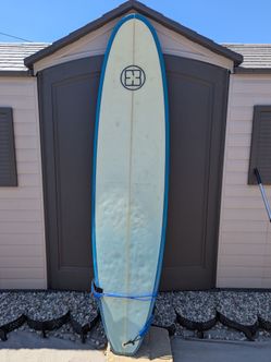 7'6” XBlue Surfboard with fins, leash, and board sock