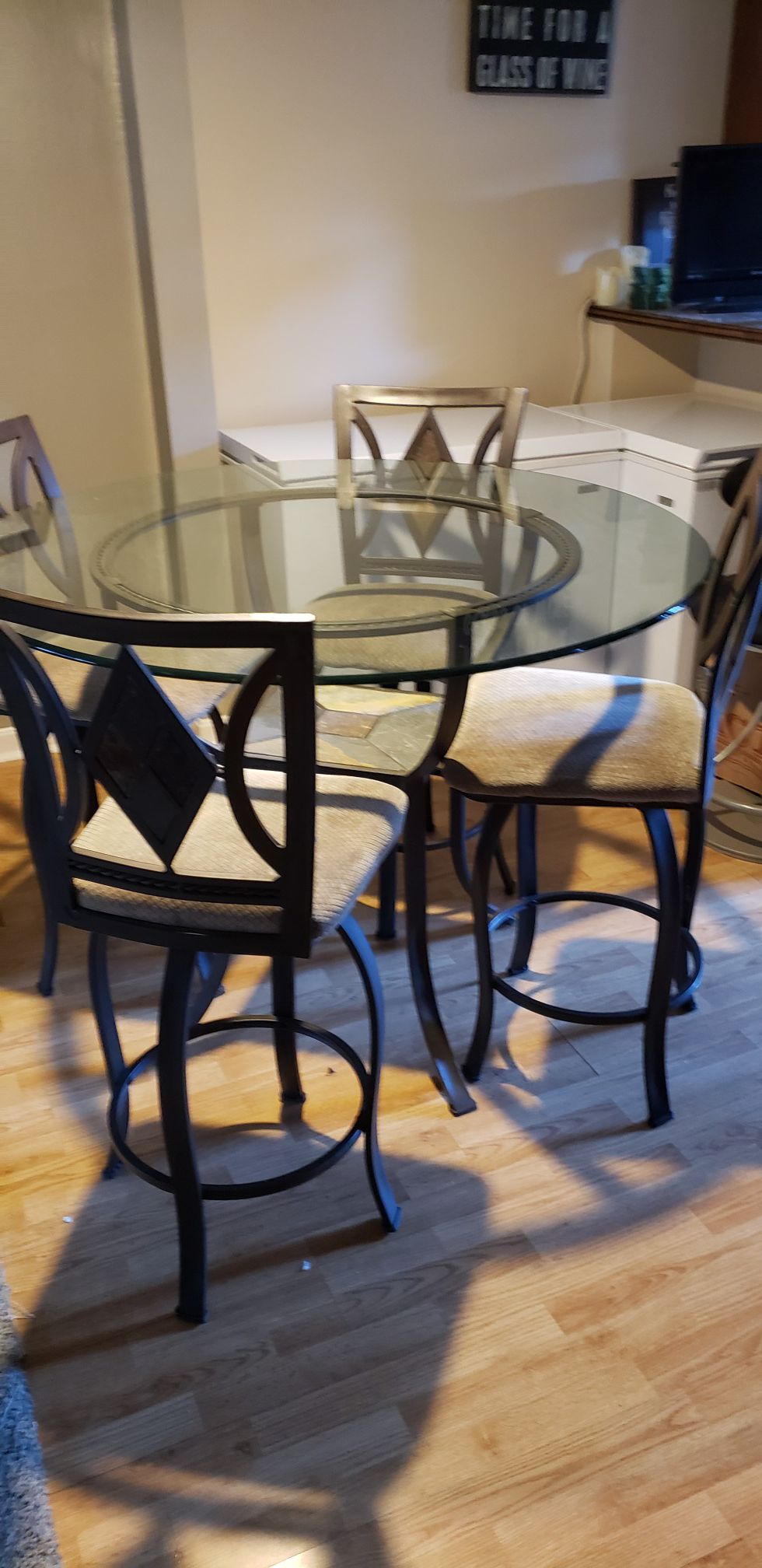 Round glass dining table four iron chairs