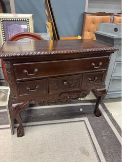 mahogany Chippendale style lowboy cabinet features distinctive shell carvings and traditional ball-and-claw feet.