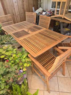 Teak table with built-in leafand6 chairs