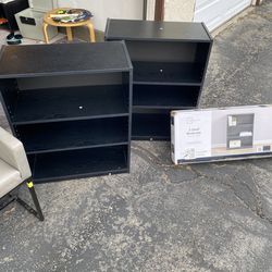 Two black three shelf bookshelf