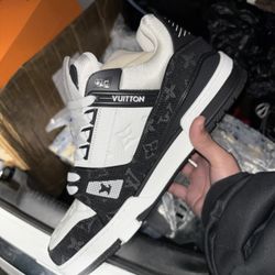 This is a Louis Vuitton LV sneaker in a black and white colorway