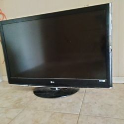 LG flat screen black standing TV