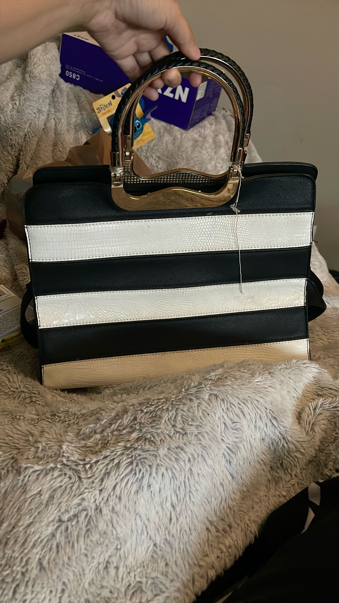 Black And White Striped Bag With A Gold Handle