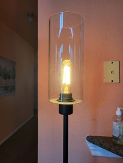 Modern floor lamp with glass shade. Foot switch. Works great. About 5 ft tall