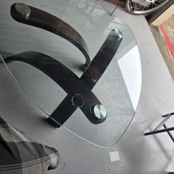 Magnussen Home Allure pie-shaped cocktail table with a glass top and a walnut veneer base in a hazelnut finish. 