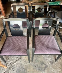 4 black chairs with padded seats
