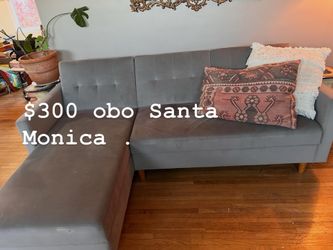 L shaped gray sofa with storage. Confirms to day bed. Great shape and clean.