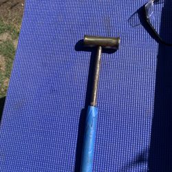  vintage hand-forged multi-tool or a machinist's brass hammer, likely used for delicate work to avoid damaging surfaces. 