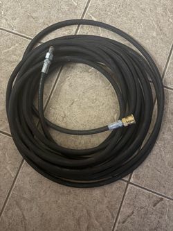 commercial-grade black rubber high-pressure hose (commonly 3/8" inner diameter, rated up to 3,000–4,000 PSI).