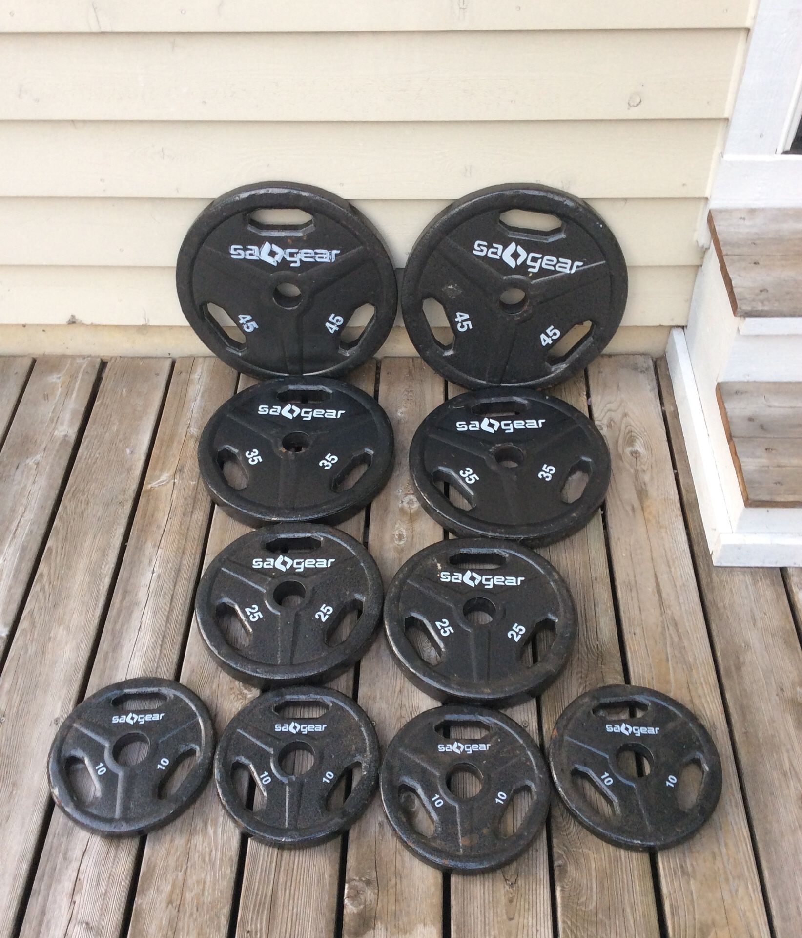 240 lbs. Olympic “SA GEAR weights - 2x 45 lb plates, 2x 35 lb plates, 2x 25 lb plates, & 4x 10 lbs plates