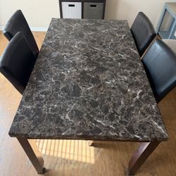 Granite Top Table And Black Chairs 