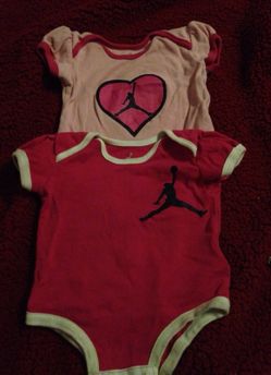 2 Air Jordan 0-3 onesies.