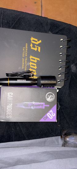 Tattoo machine with practice book and needles