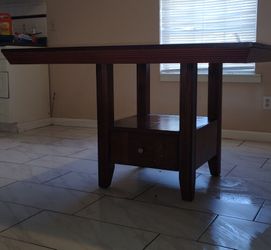 Solid wood dining table with storage