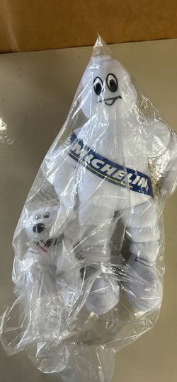 This item is a vintage-style Michelin Man (Bibendum) plush advertising collectible, featuring a small pup mascot and still in its original packaging. 