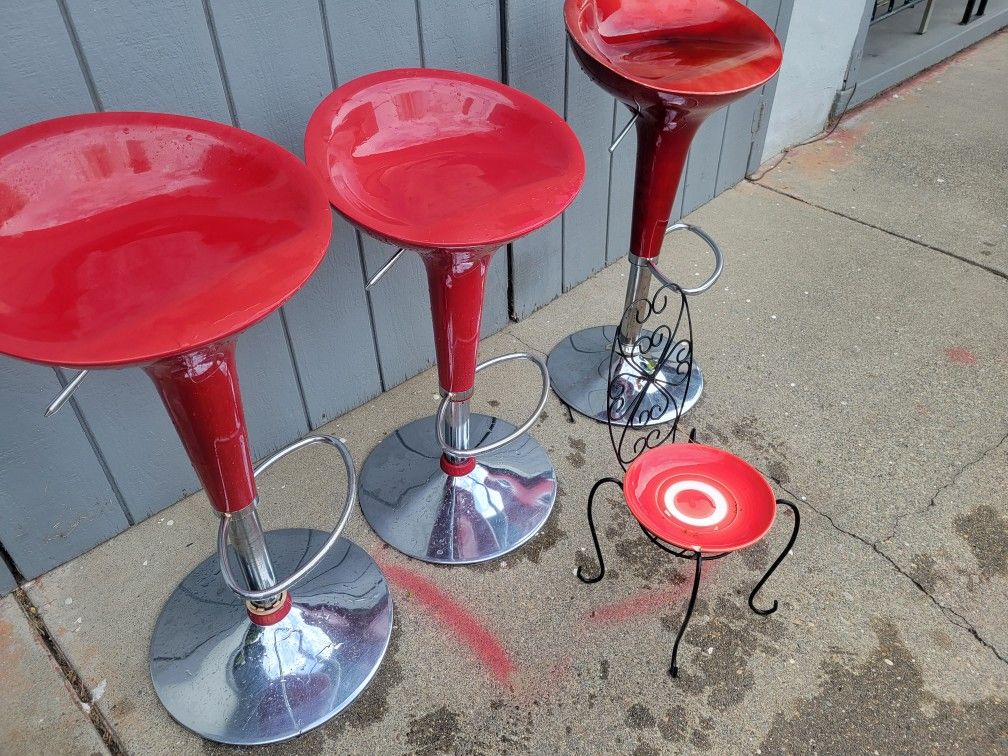 Three red bar chairs