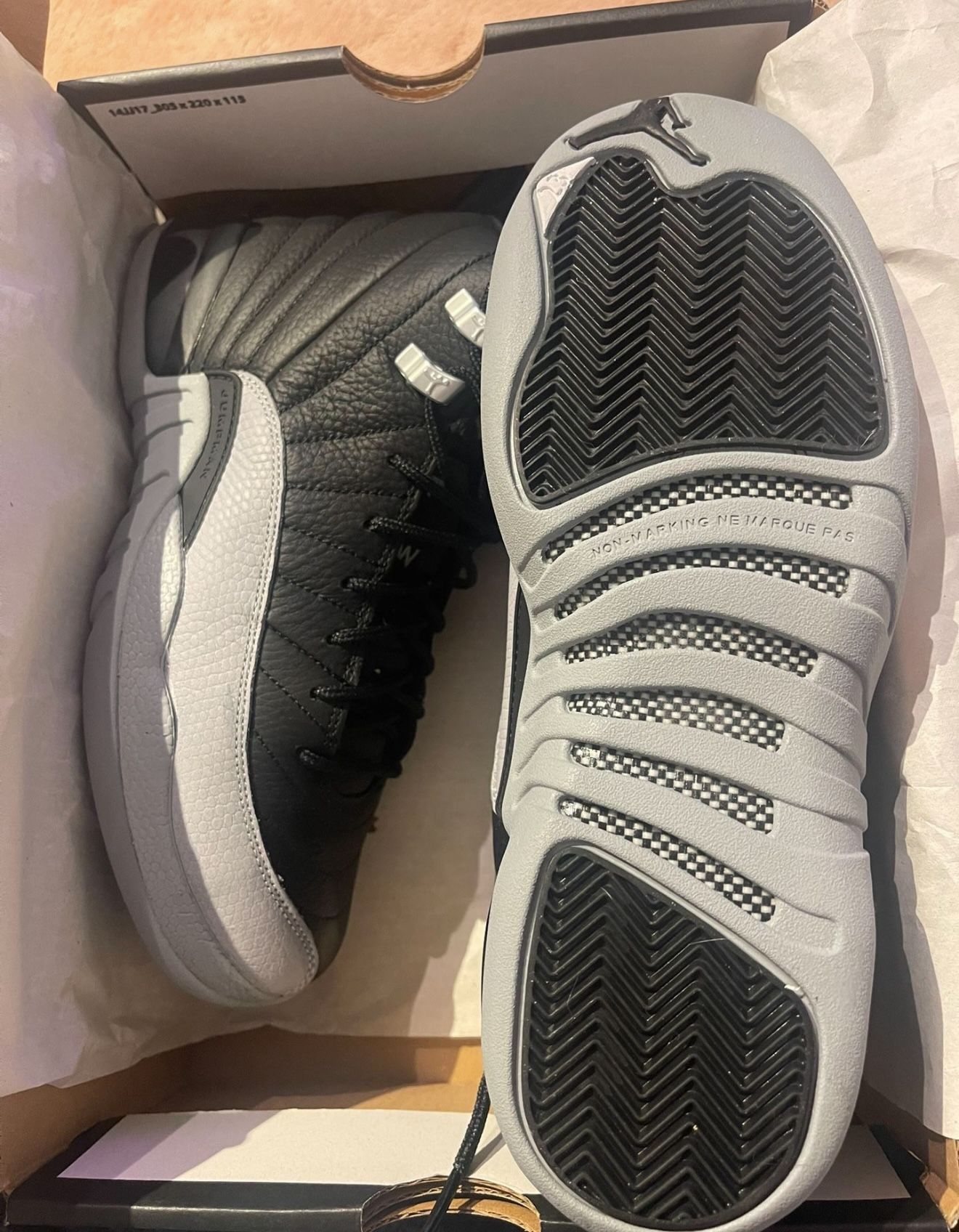 Air Jordan 12 Retro (GS) in Black/Wolf Grey in size 6.5Y, brand new, never worn.