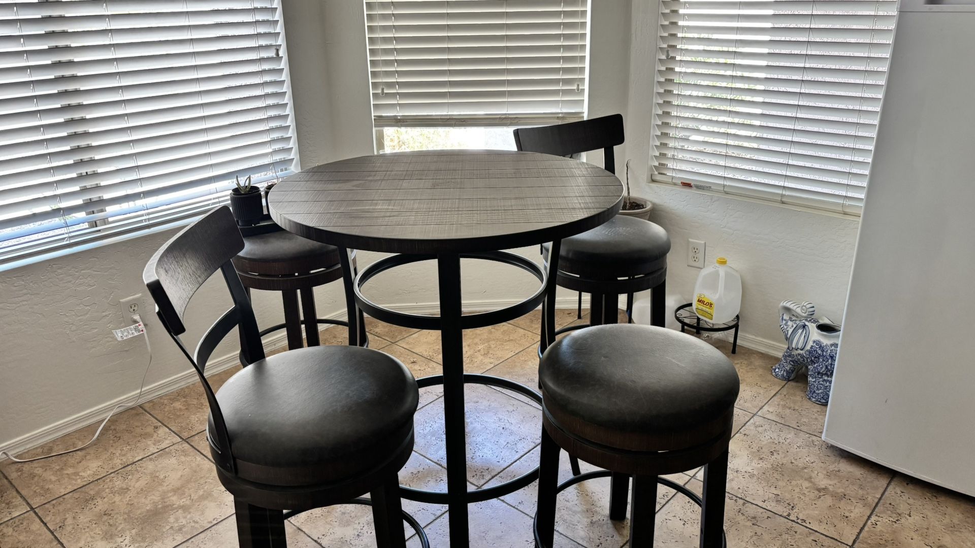Table With Four Swivel Stools