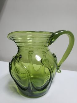 Emerald green art glass pitcher w/ applied cradle