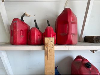 5 red gasoline containers