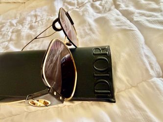 Christian Dior sunglasses with a gold frame.