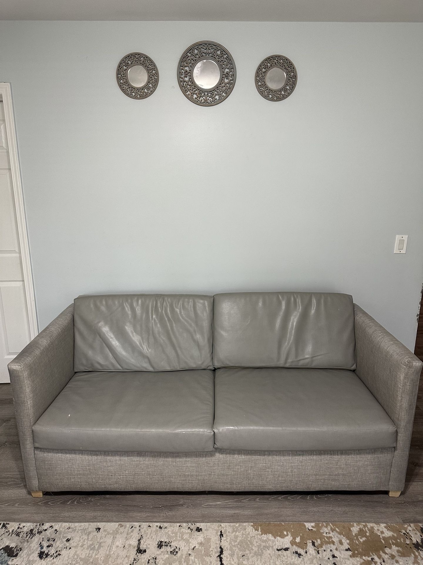 Marquis Sleeper Sofa/ Gray two-seater sofa with a fabric base and leather cushions