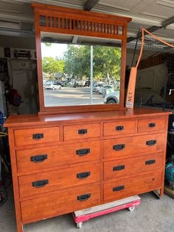 Solid wood dresser with mirror.