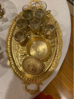 vintage Middle Eastern/Turkish brass tea or coffee serving set. It appears to include:  * Large engraved brass serving tray * 6 glass tea cups in bras