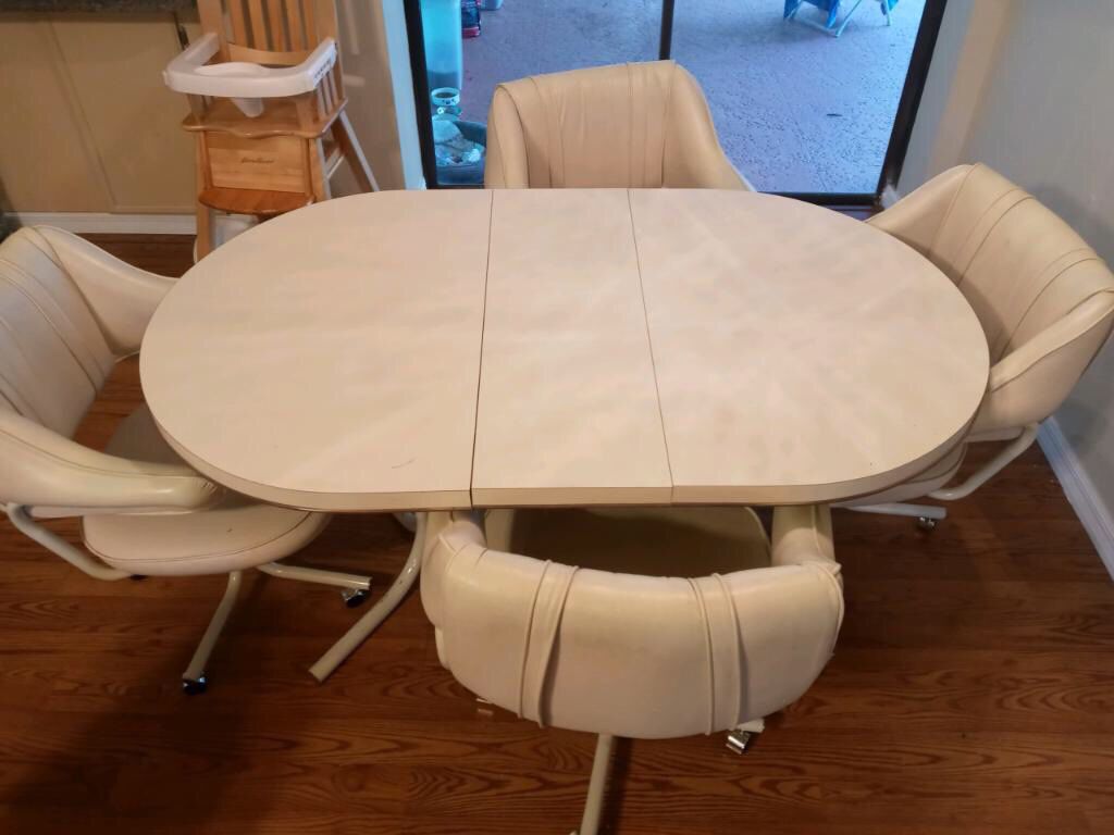 Oval table with rolling chairs
