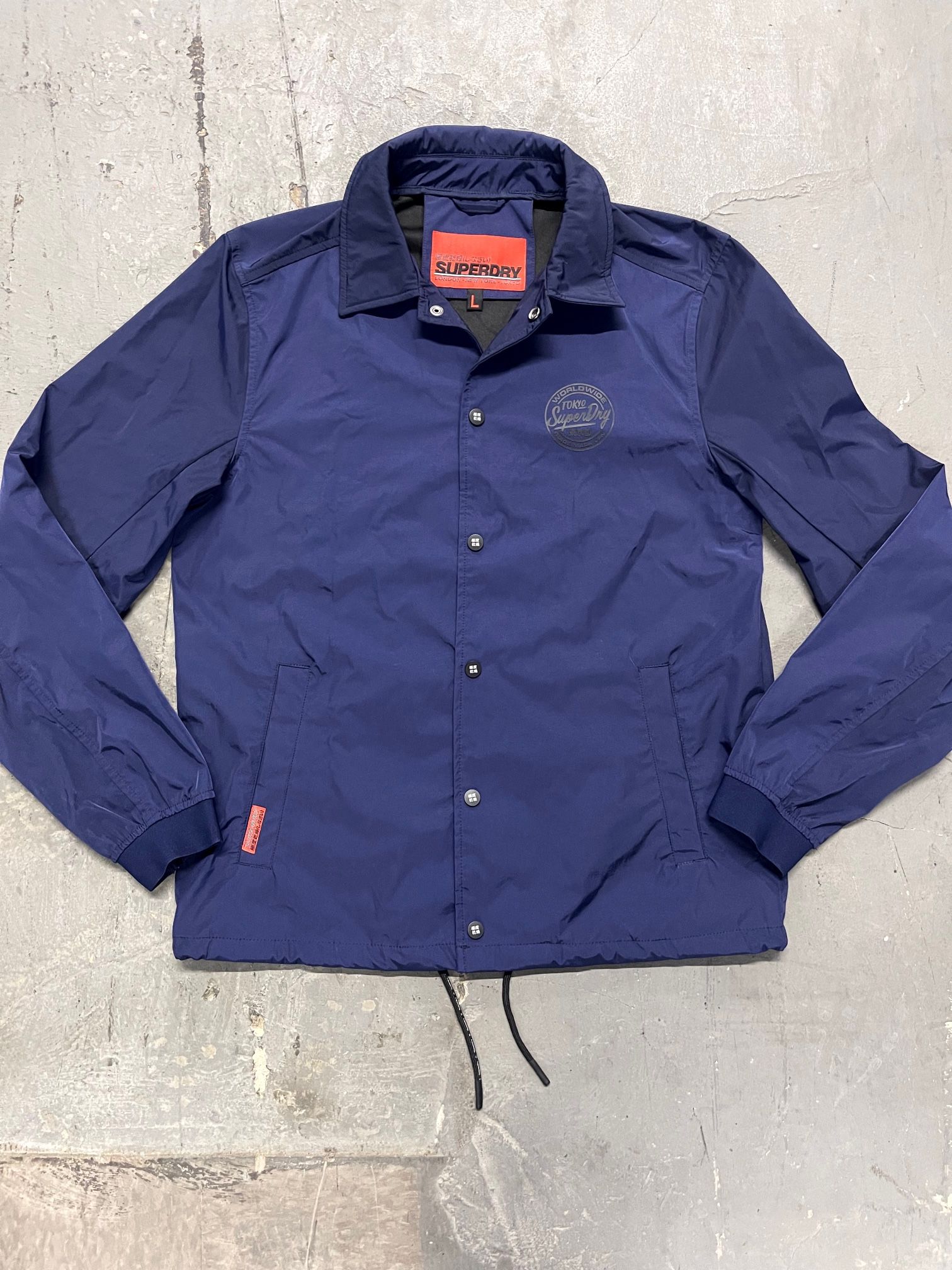 New! Mens Superdry Skate Lux Coach jacket. Size Large. Retail $80. Brand new never worn. With snap button closure. Color navy blue.