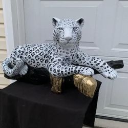 Snow Leopard On The Log 