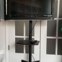 31 1/3” TV VIZIO Model VO320E With TV Rolling Stand MT 2004 And Shelf
