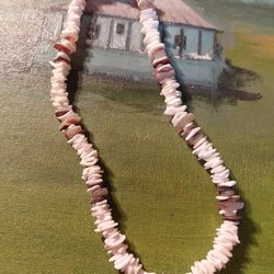This is a brown and white puka shell necklace. 