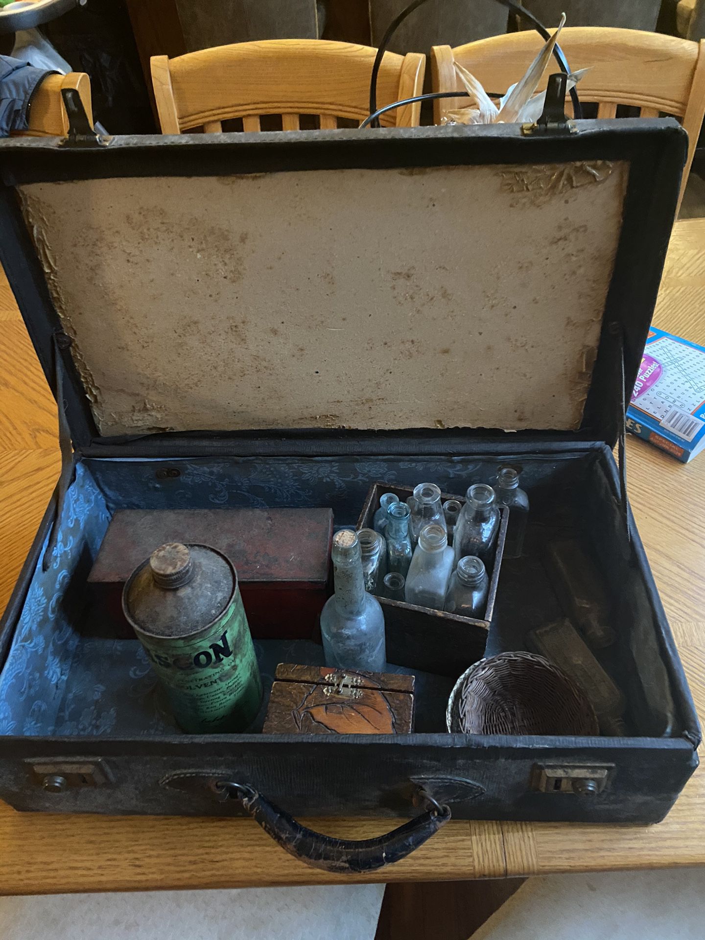 Antique suitcase with items inside