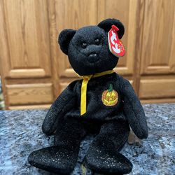 Ty Beanie Babie “Haunt” .   year 2000.  Size  7 inches tall.  Sits  up.  Brand New with Tags has been on display in a cabinet with