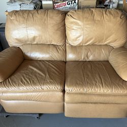 Tan Reclining loveseat.