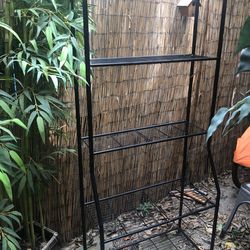 Black metal shelf asking $40 obo about 6 ft tall