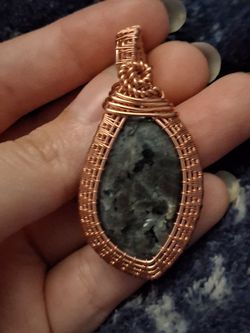 Intricate handcrafted larvakite pendant