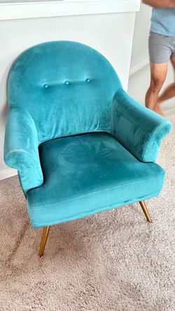 Tufted arm chair with brass legs