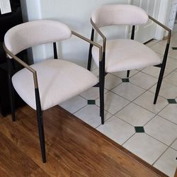 2 Beige Side Chairs with Black Metal Legs and Gold Accents