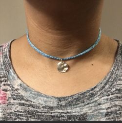 Blue braided choker necklace with golden charm