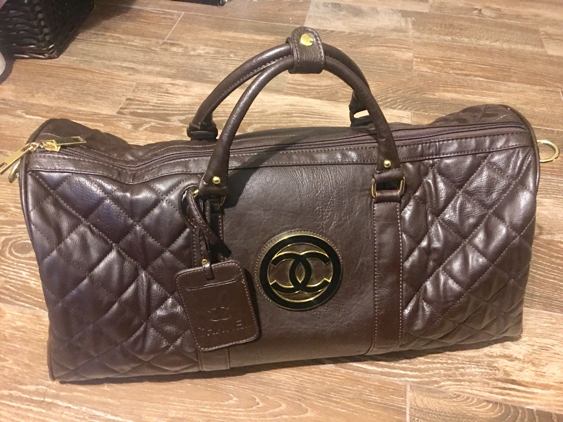 LEATHER CHANEL DUFFLE BAG WITH SERIAL LOGO ON SIDE