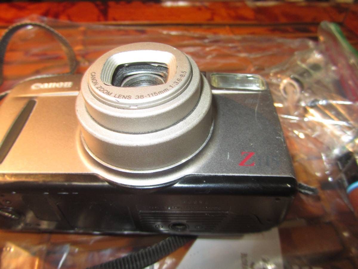 Canon Z115 35MM Point and Shoot Film Camera with built-in Flash and auto film rewinder as well as zoom lens. New Batteries Included Condition: Like Ne