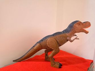 Electronic T-Rex Dinosaur Toy with Light-Up Eyes and Sound.Interactive T-Rex dinosaur toy stands approximately 11 inches tall.  The plastic figure is 