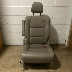 Honda Odyssey Single Leather Back Seat with Right Arm Rest  Exact years of compatibility are unknown.  Great pre-owned condition.   Pick up available 