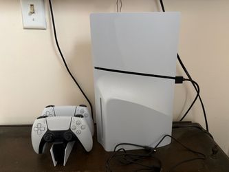 PlayStation 5 with two DualSense controllers and charging port