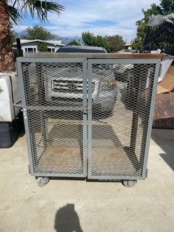 Metal storage container with locking doors on wheels