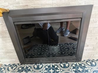 black cabinet-style/bi-fold glass fireplace door